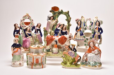 Lot 76 - A collection of Staffordshire figures and three stoneware jugs, mainly 19th century