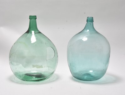 Lot 8 - A pair of large green glass carboys, 19th century